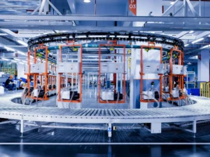 OEM Solutions a large machine in a factory with people working on it